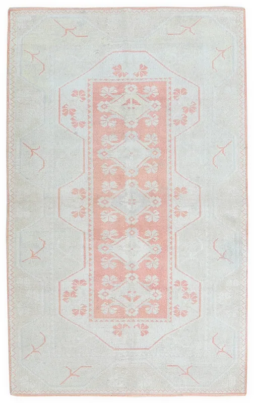 Full top view of the vintage cream and pink Anatolian rug on a white background