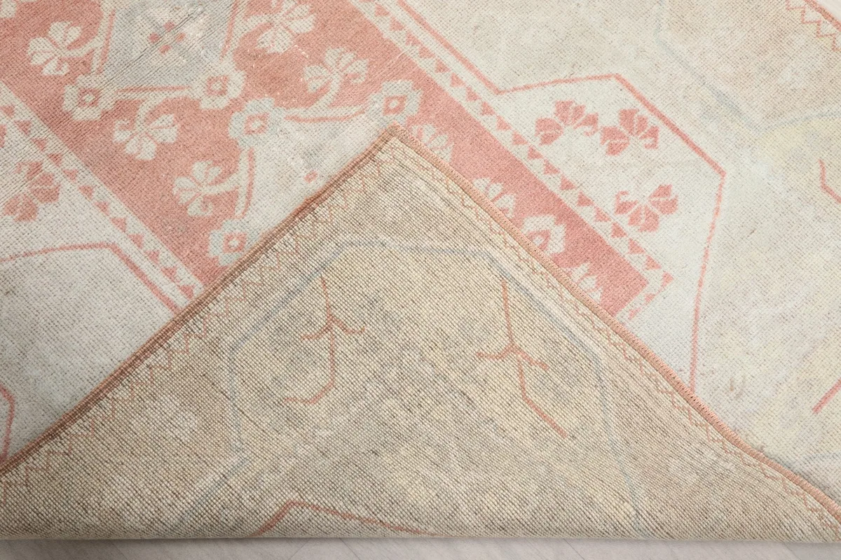 Underside of the rug, revealing the cotton foundation and knotting structure