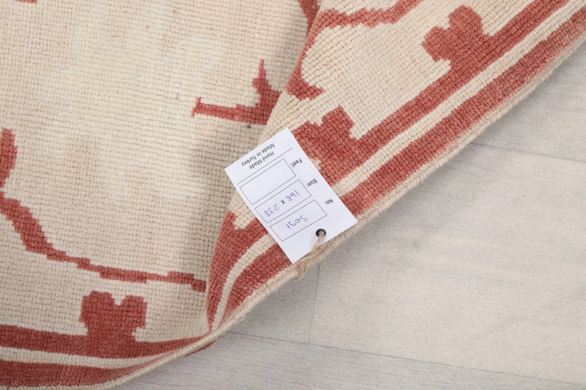 Close-up of the rug's label, indicating its dimensions and origin.