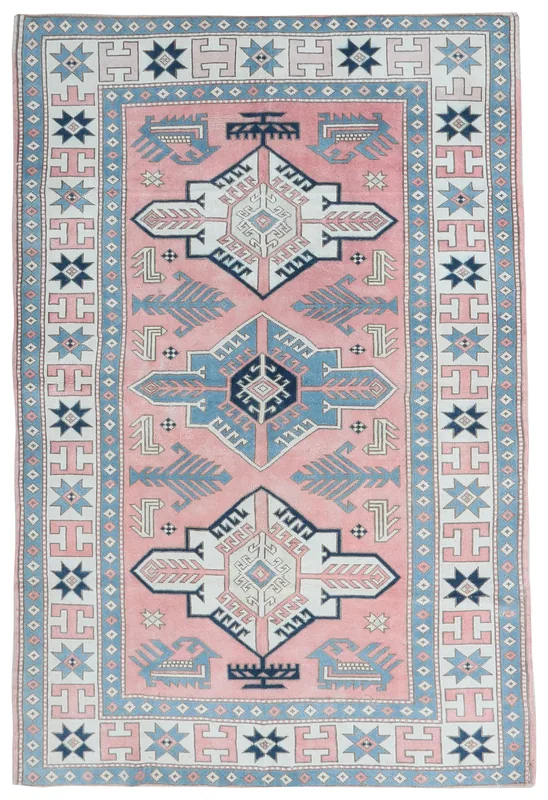 Full overhead view of the rose, blue, and ivory geometric vintage Anatolian rug