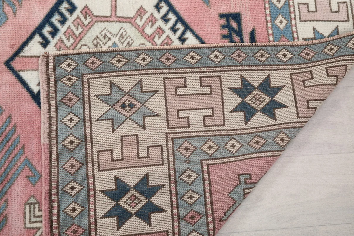 Another view of the folded corner, showing the rug's construction and colors