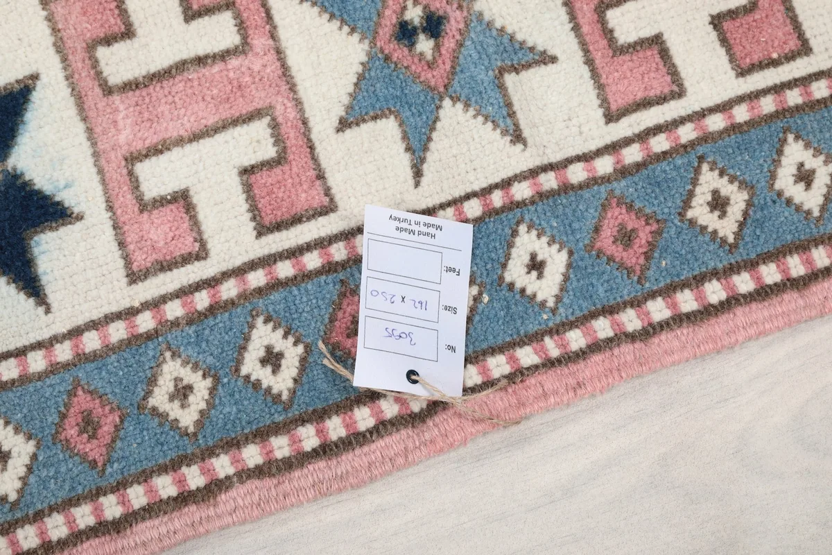 Close-up of the rug's edge and tag with size and material information