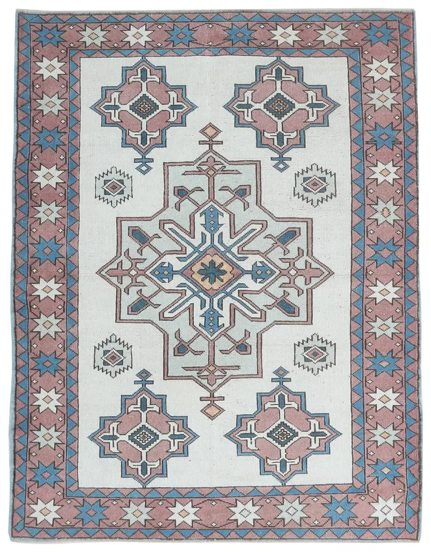 Full top view of an ivory field rug with rose border and geometric motifs
