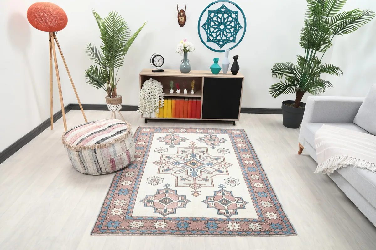 Ivory and rose geometric rug displayed in a modern living room setting