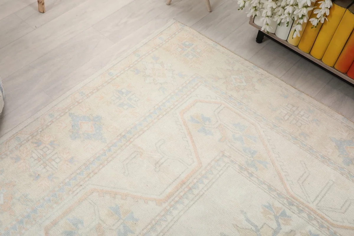 Diagonal view across the rug, capturing the soft patina and motif details