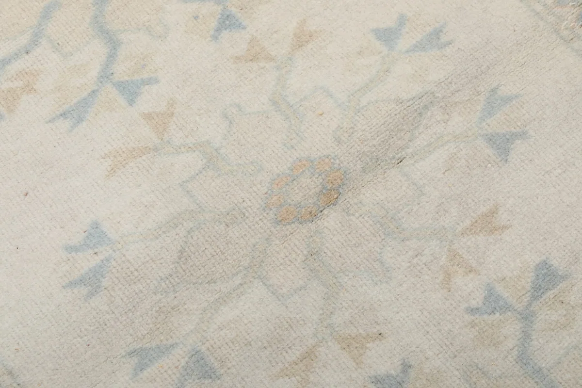 Macro detail of the hand-knotted wool pile and a specific floral element