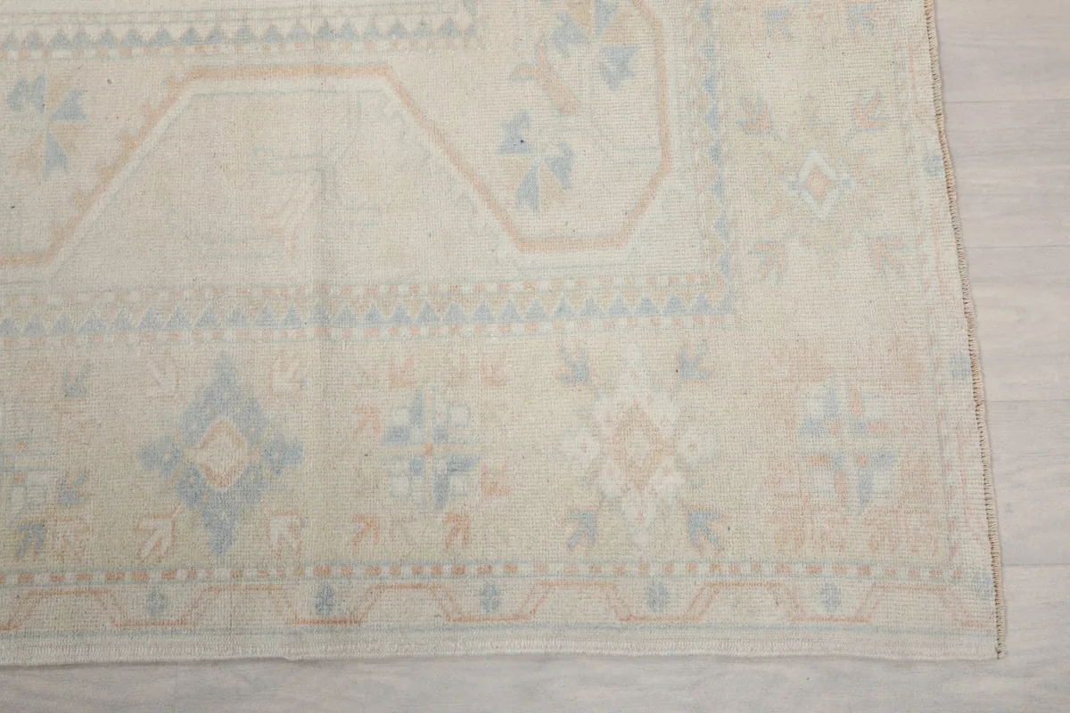 Detail of the rug's border and corner, showing geometric patterns and colors