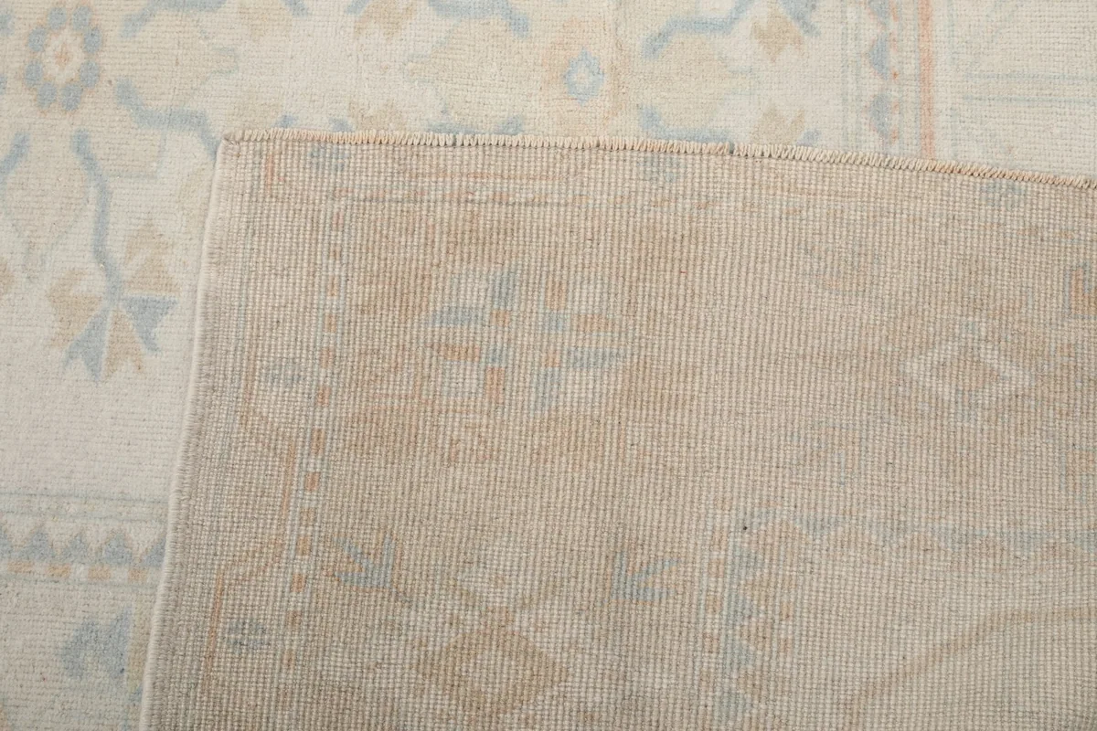 Close-up of the back of the rug, showing the hand-knotted cotton foundation