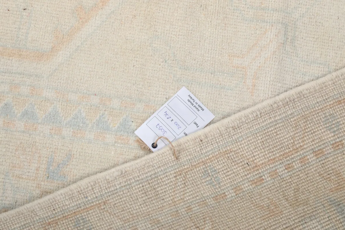 Product tag attached to the back of the vintage hand-knotted rug