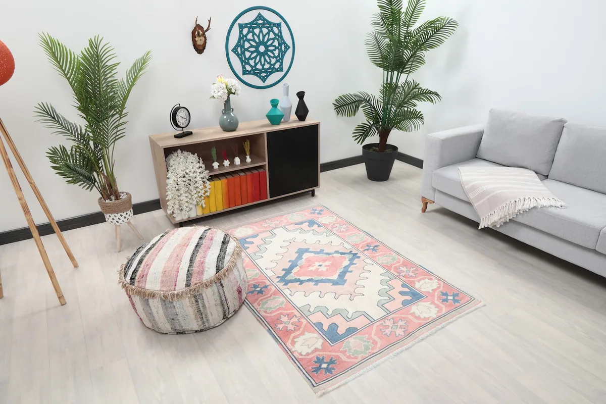 Overhead view of the rose and ivory rug in a room, showing its placement relative to furniture