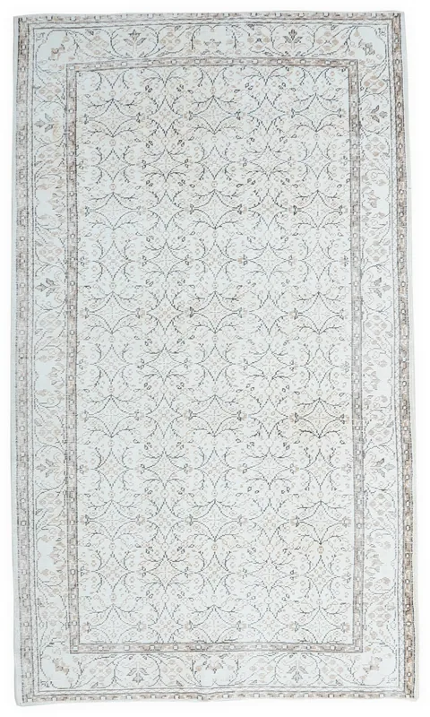 Full overhead view of the 6x9 ivory vintage Anatolian rug with geometric patterns