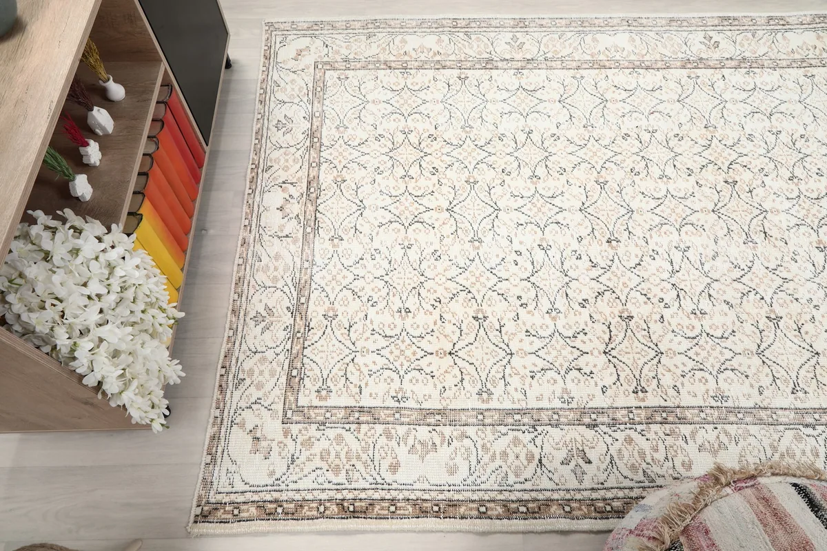 Angled view of the rug from above, capturing the full pattern and slight patina