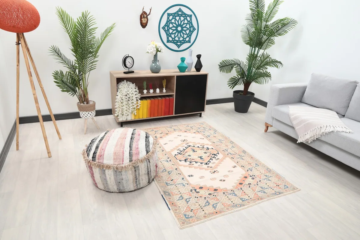 Angle view of the rug in a living room, showing its placement relative to a sofa and ottoman