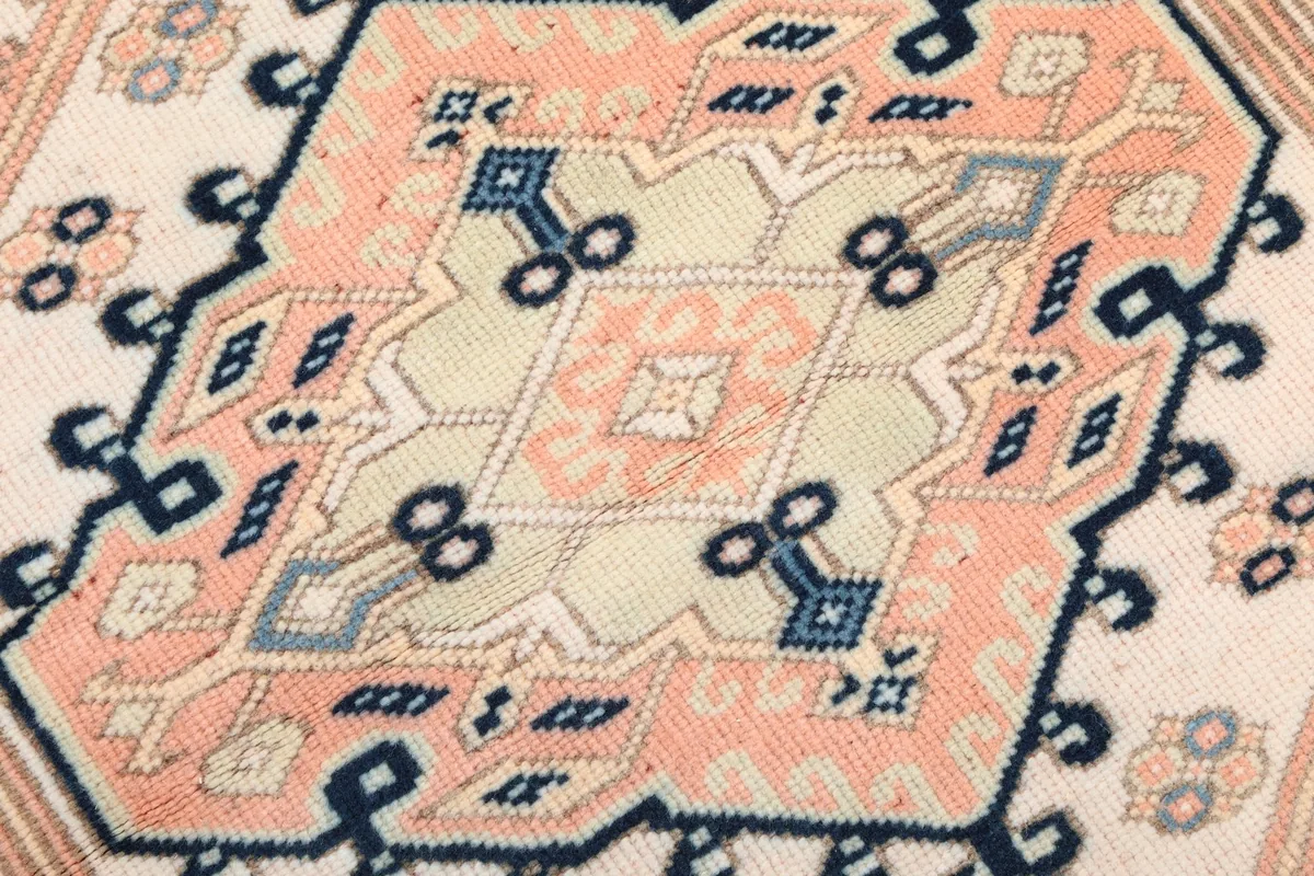Extreme close-up of the central design element within the medallion, highlighting knotting