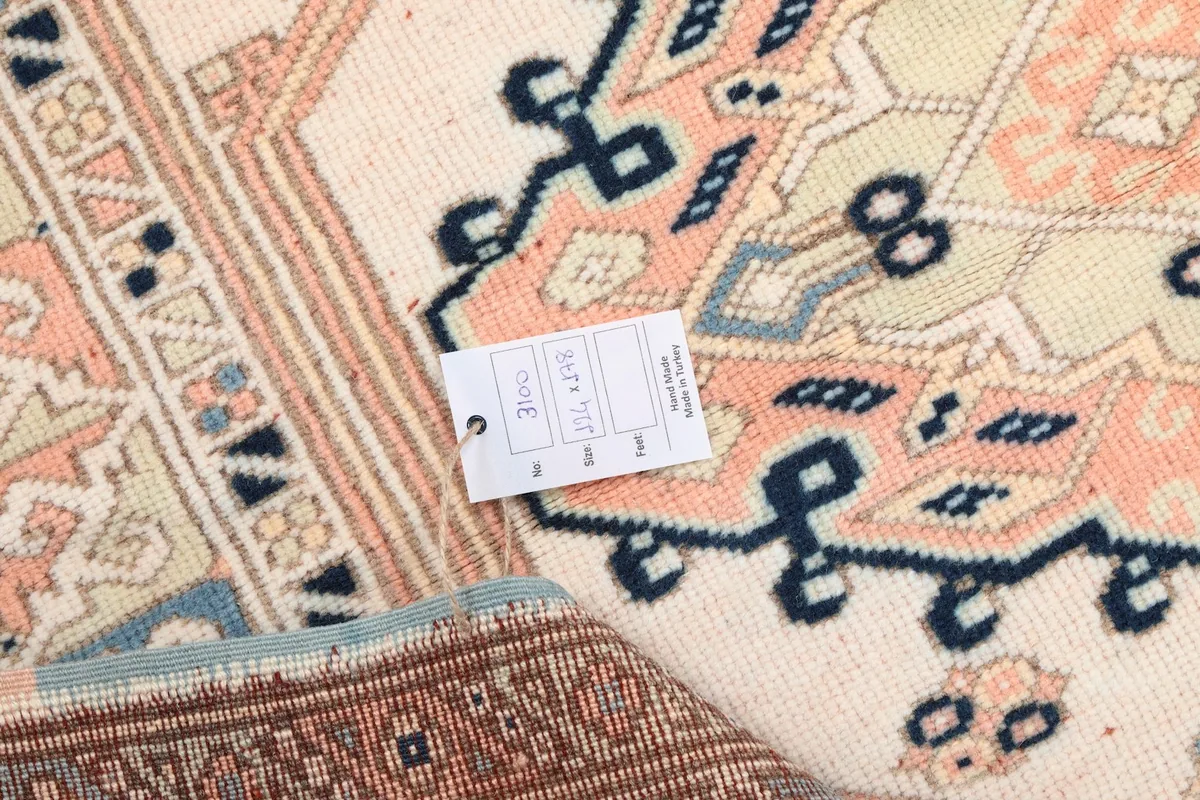Detail of the rug with a product tag showing dimensions and material information