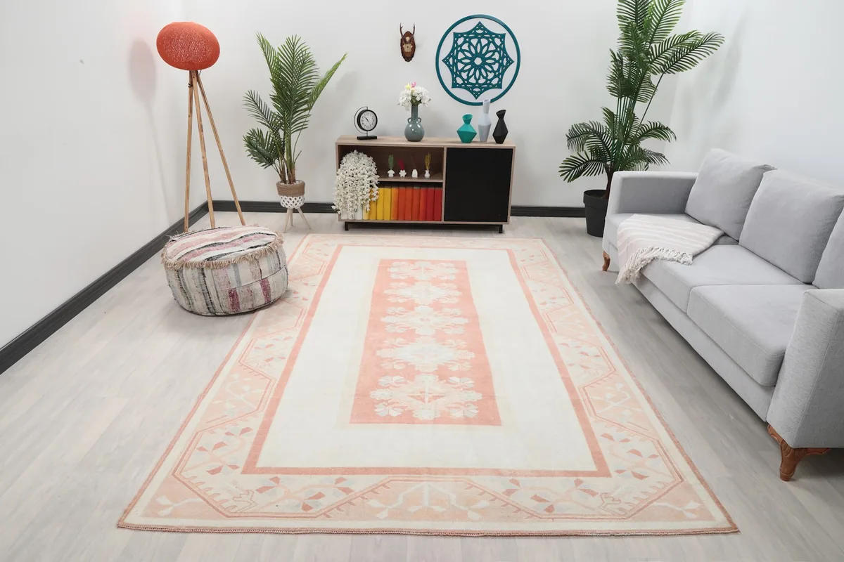 Vintage ivory and rose area rug in a modern living room setting