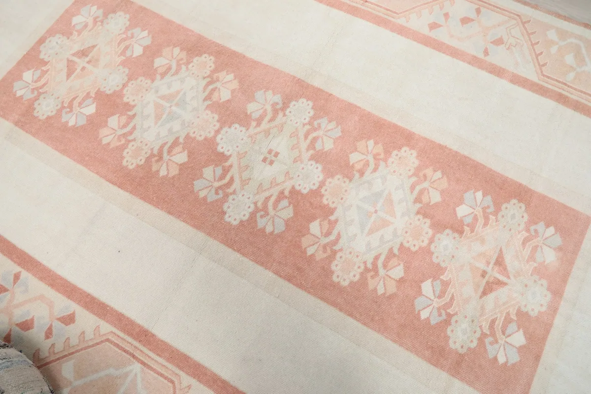 Overhead close-up of the central rose panel with geometric floral motifs