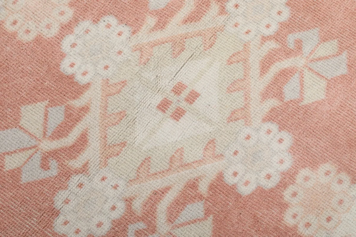 Close-up of the hand-knotted wool pile and geometric floral detail
