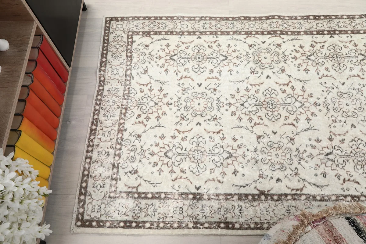 Angled view looking down on the rug, capturing the full pattern and its interaction with the surrounding decor.