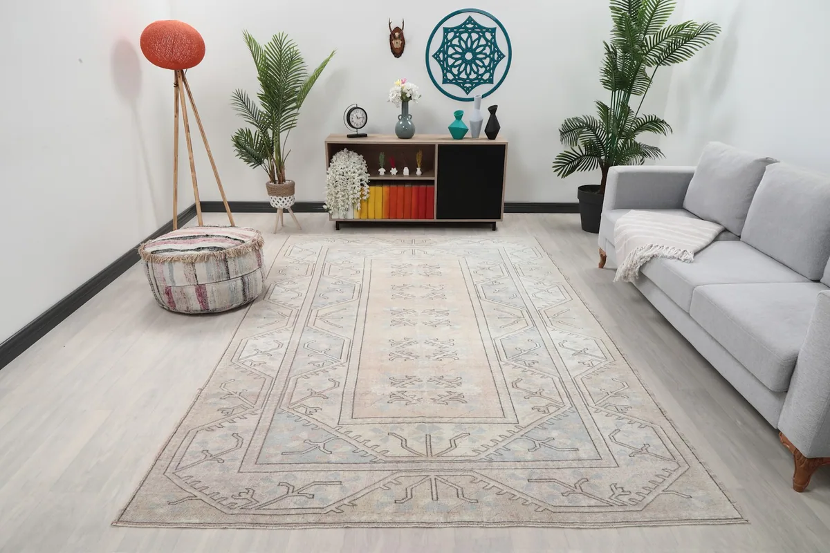 Vintage beige and blue geometric rug displayed in a modern living room setting