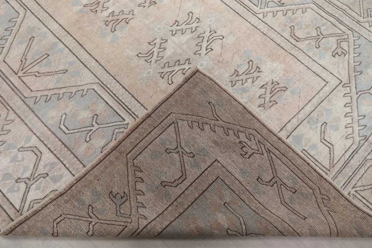 View of the rug's back, revealing the hand-knotted cotton foundation and wool pile