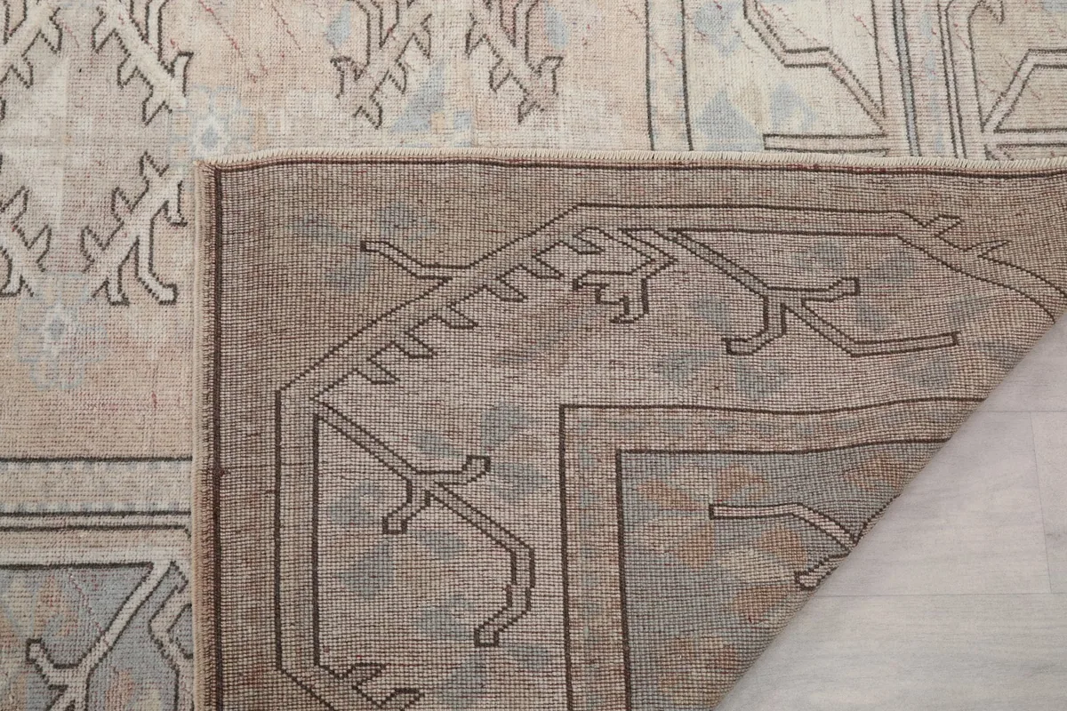 Folded corner of the rug showing the reverse side and construction details