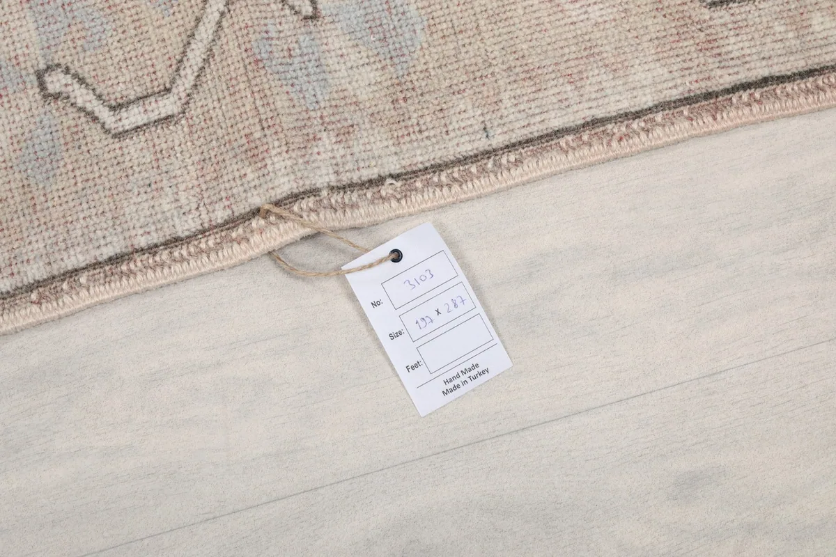 Close-up of the rug's edge with a product tag, indicating origin and material