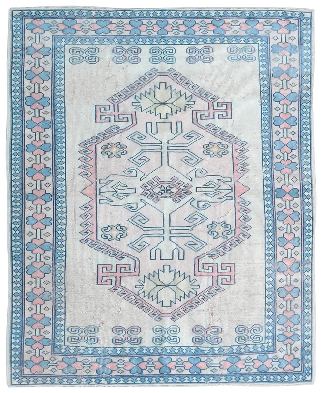 Full top view of the ivory, blue, and pink geometric vintage Anatolian rug
