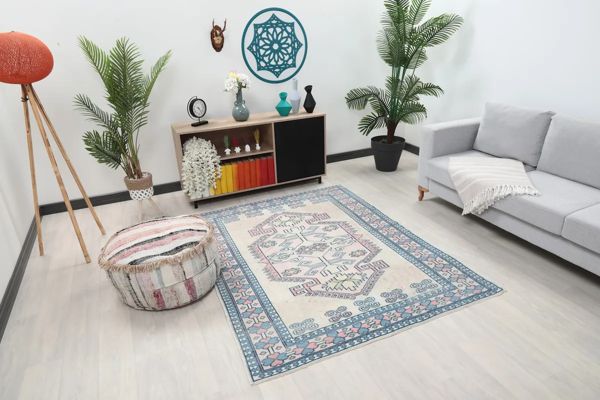 Angle view of the geometric rug in a living space with a striped ottoman