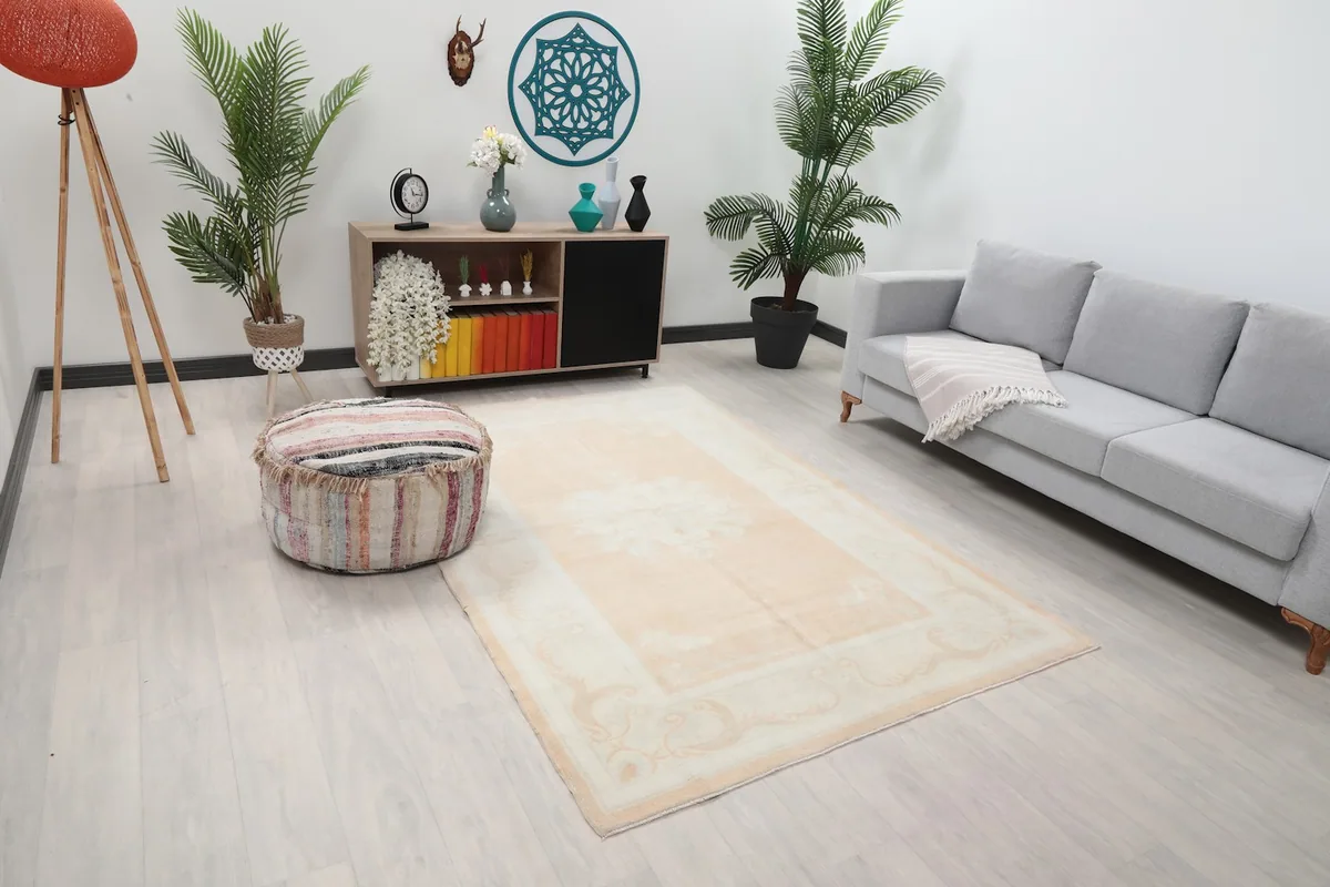 Overhead view of the vintage Anatolian rug in a room, showing its placement relative to a sofa