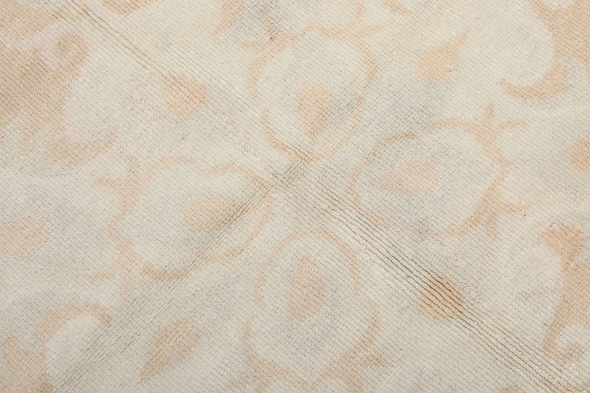 Close-up of the low wool pile texture and subtle color variations in the rug