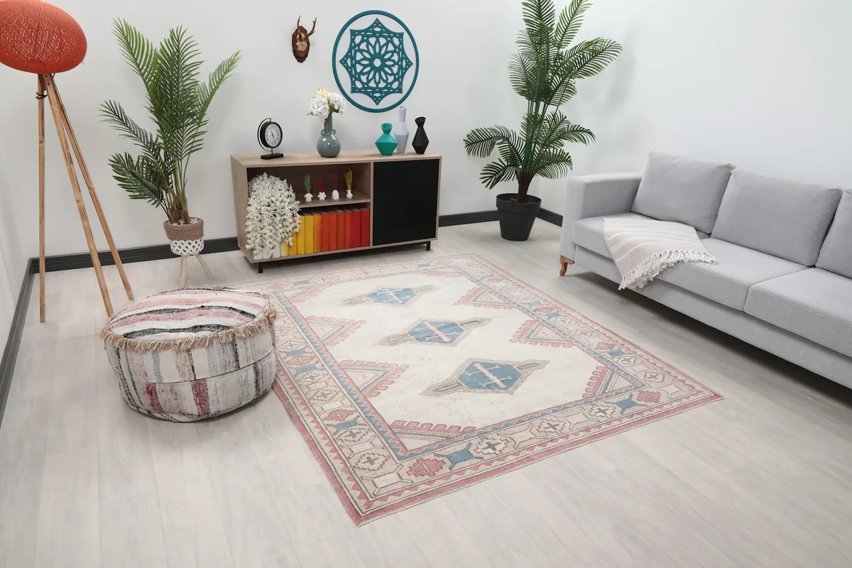 Angle view of the ivory, blue, and rose tribal rug in a contemporary living space