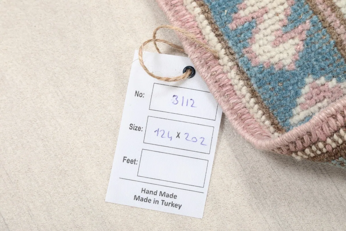 Close-up of the rug's tag, indicating its size and hand-made origin from Turkey