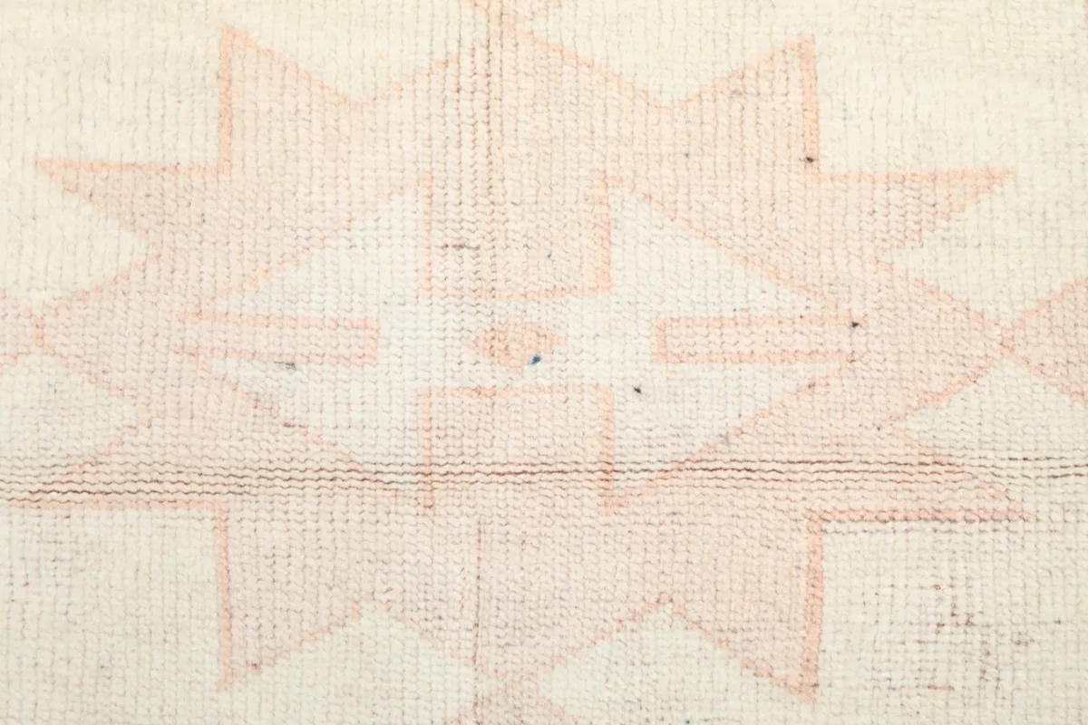 Detailed close-up of the low wool pile and hand-knotted texture.