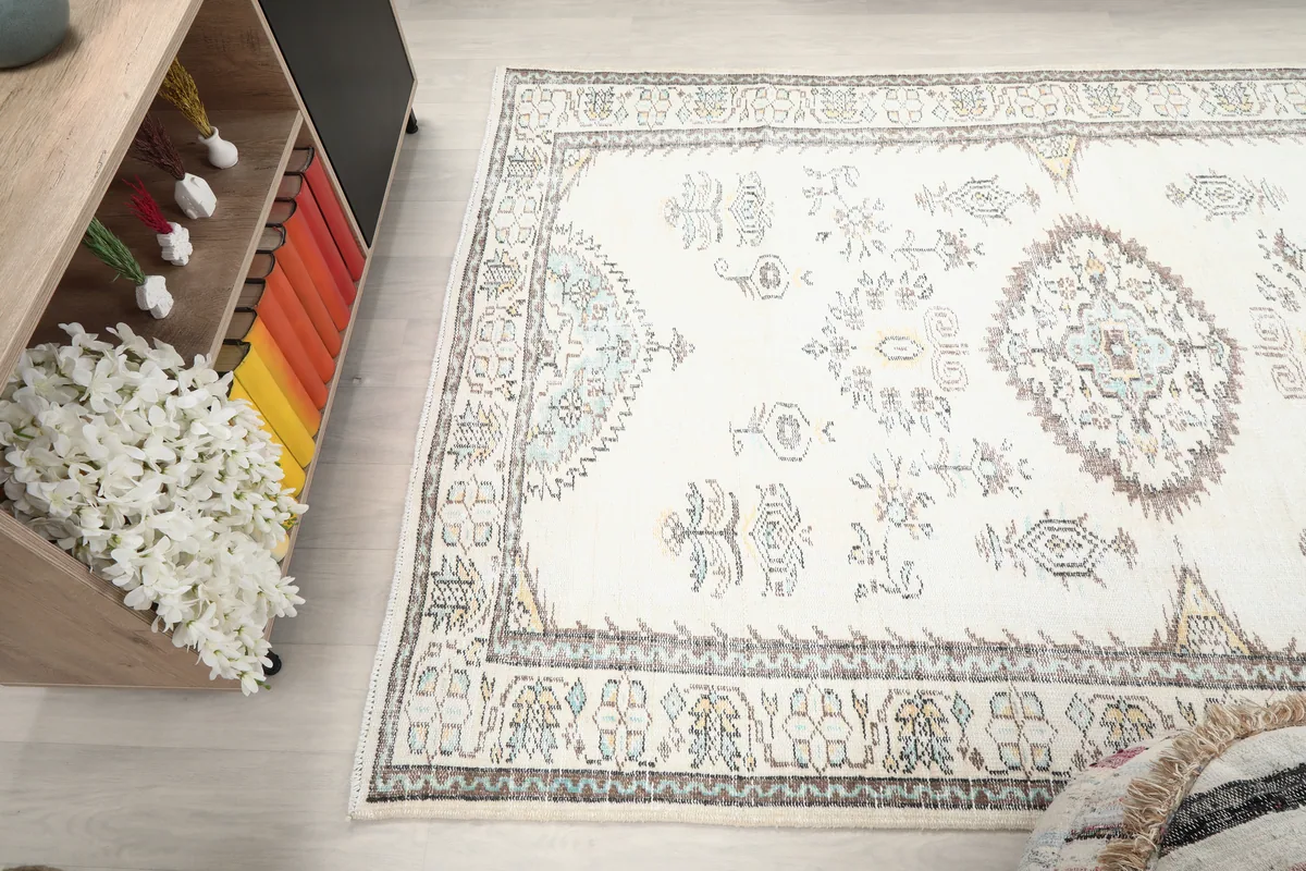 Ivory Tribal Medallion Rug from a corner angle, showing the field and border patterns.