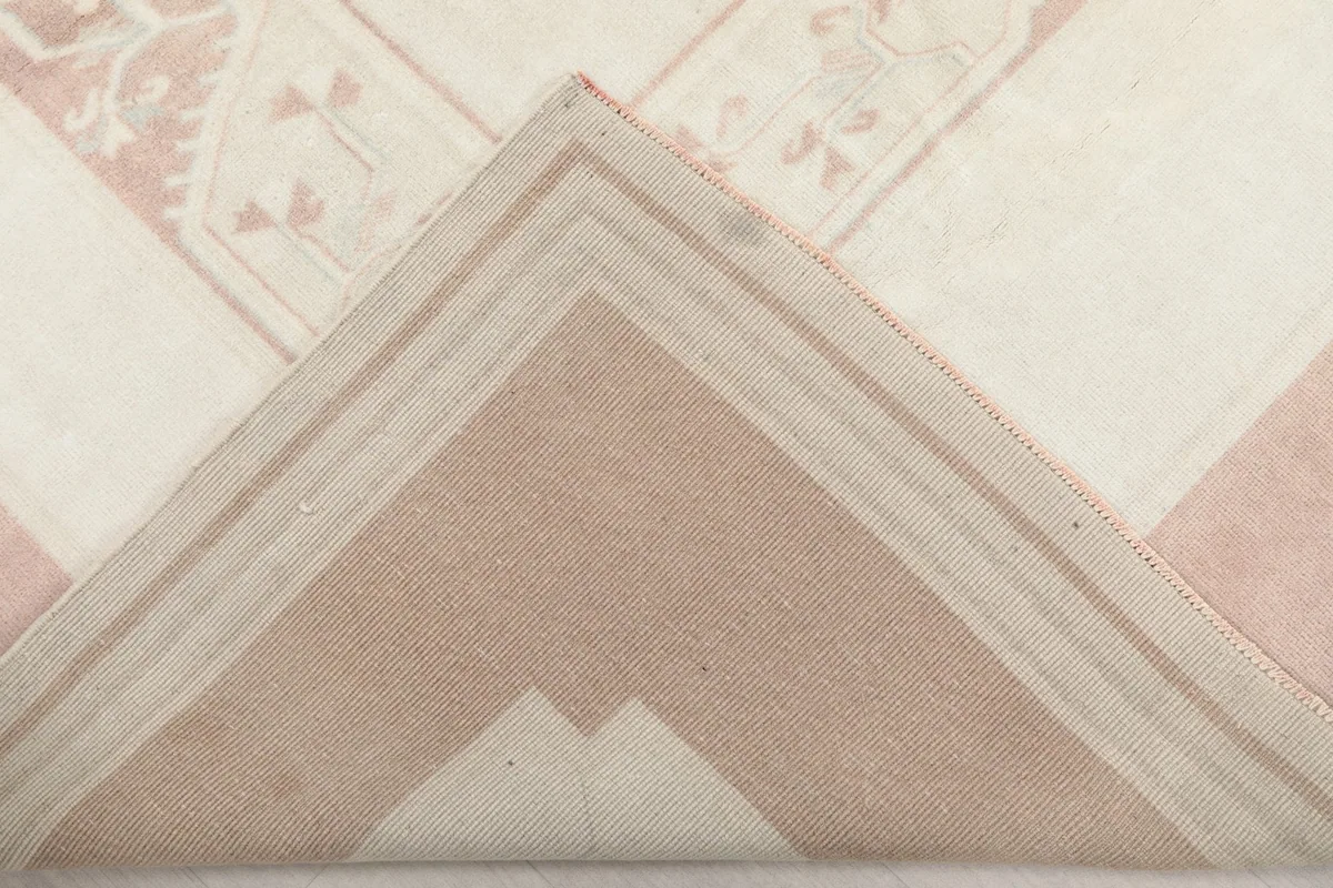 Underside view of the rug, showing the cotton foundation and knotting structure