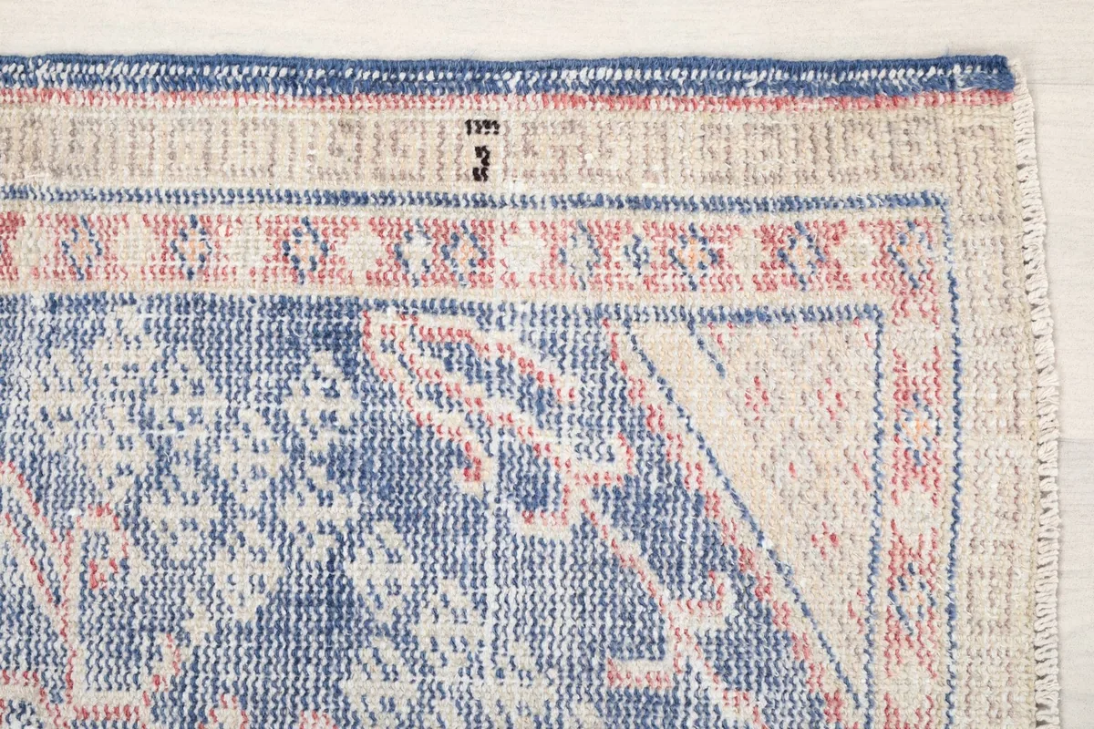 Detailed view of the upper right corner, showing geometric patterns and border design.