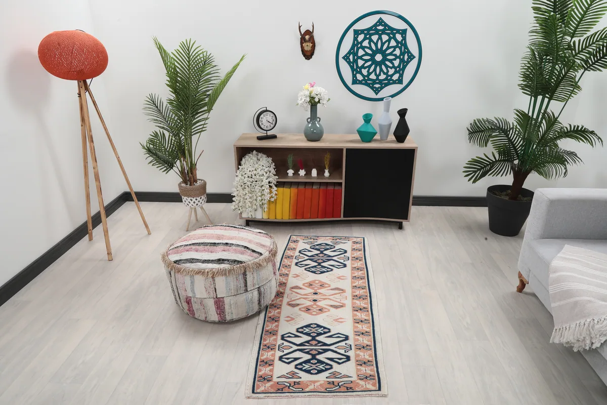 Ivory Geometric Anatolian Runner in a modern living space, showing its size and placement next to a sofa and ottoman.