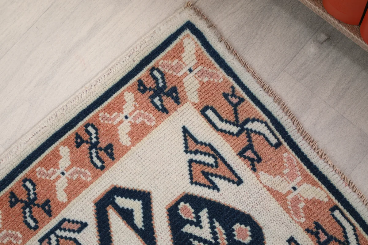 Corner detail of the Ivory Geometric Anatolian Runner, showing the intricate border design and colors.