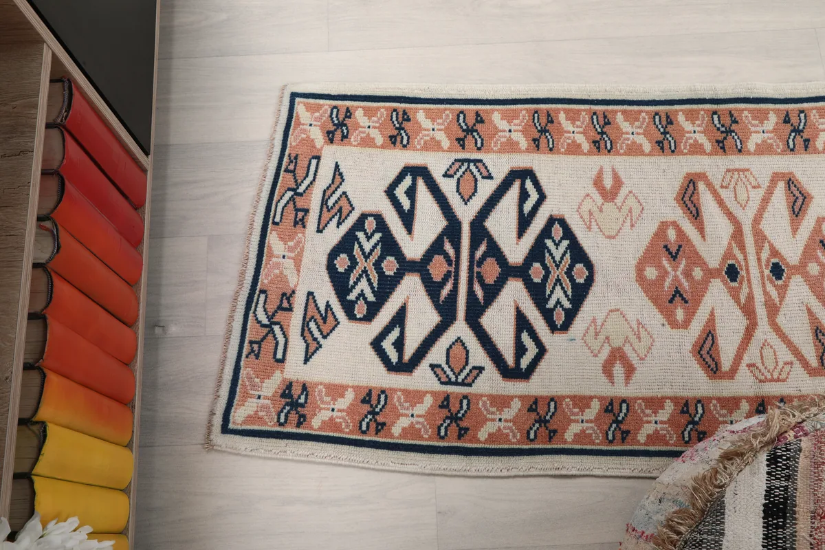 Angled top-down view of the Ivory Geometric Anatolian Runner, highlighting its overall shape and design.