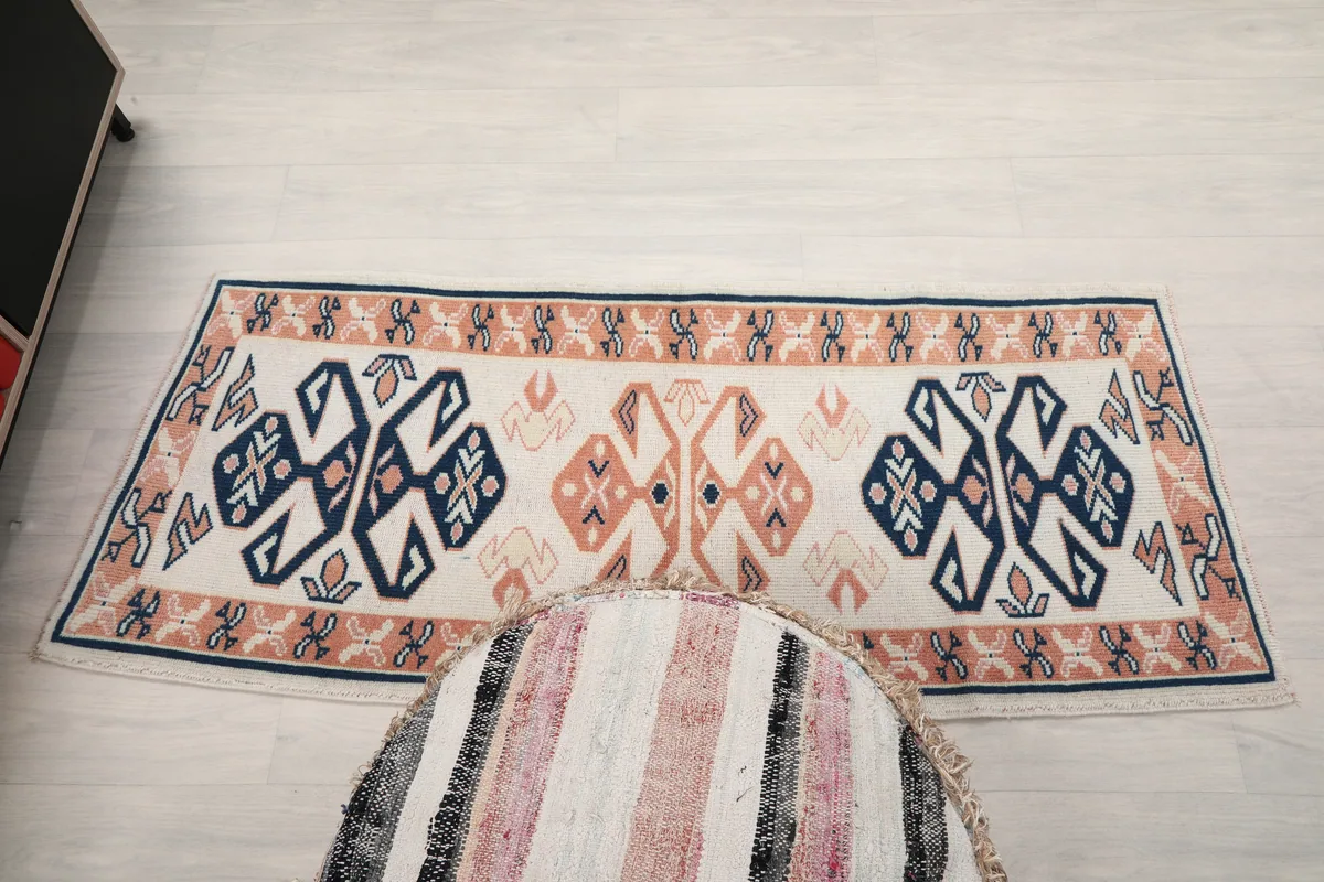 Full view of the Ivory Geometric Anatolian Runner laid out in a room, offering a complete perspective.