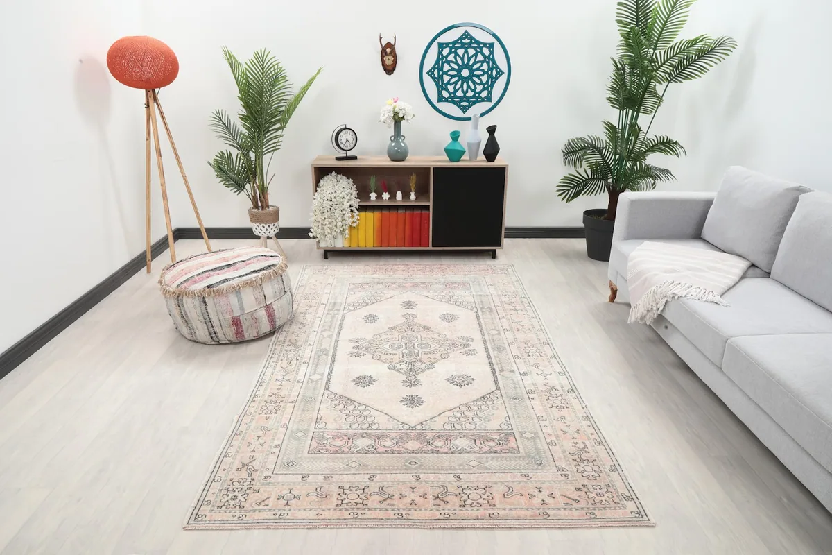 Full view of the rug styled in a modern living room setting with a light gray sofa
