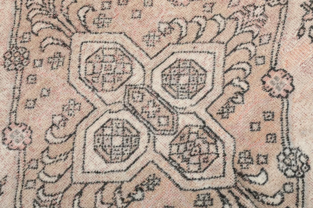 Extreme close-up of a central motif, showing the intricate knotting and color variation