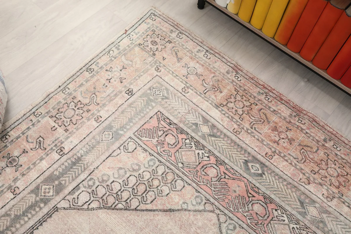 Close-up of the rug's border design, showcasing geometric patterns and color transitions