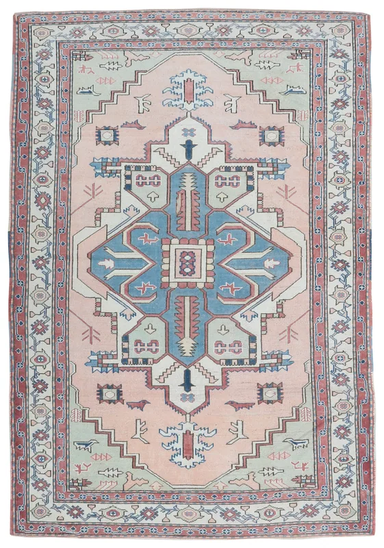 Full overhead view of the 6'7" x 9'9" rose and blue vintage Anatolian rug on a white background.