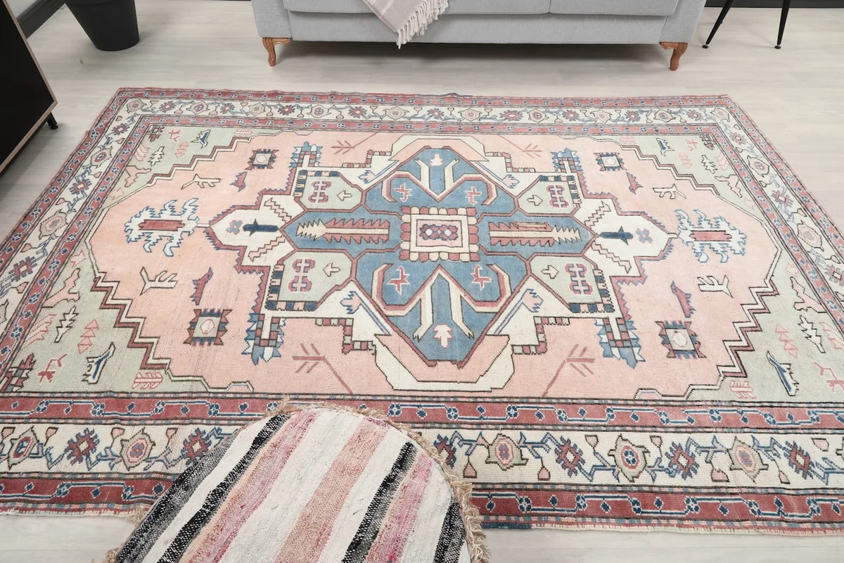 Wide shot of the rug on the floor in a living room, providing a sense of its scale and design.