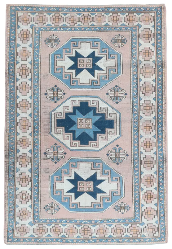 Full top view of the vintage rose and navy Anatolian rug on a white background