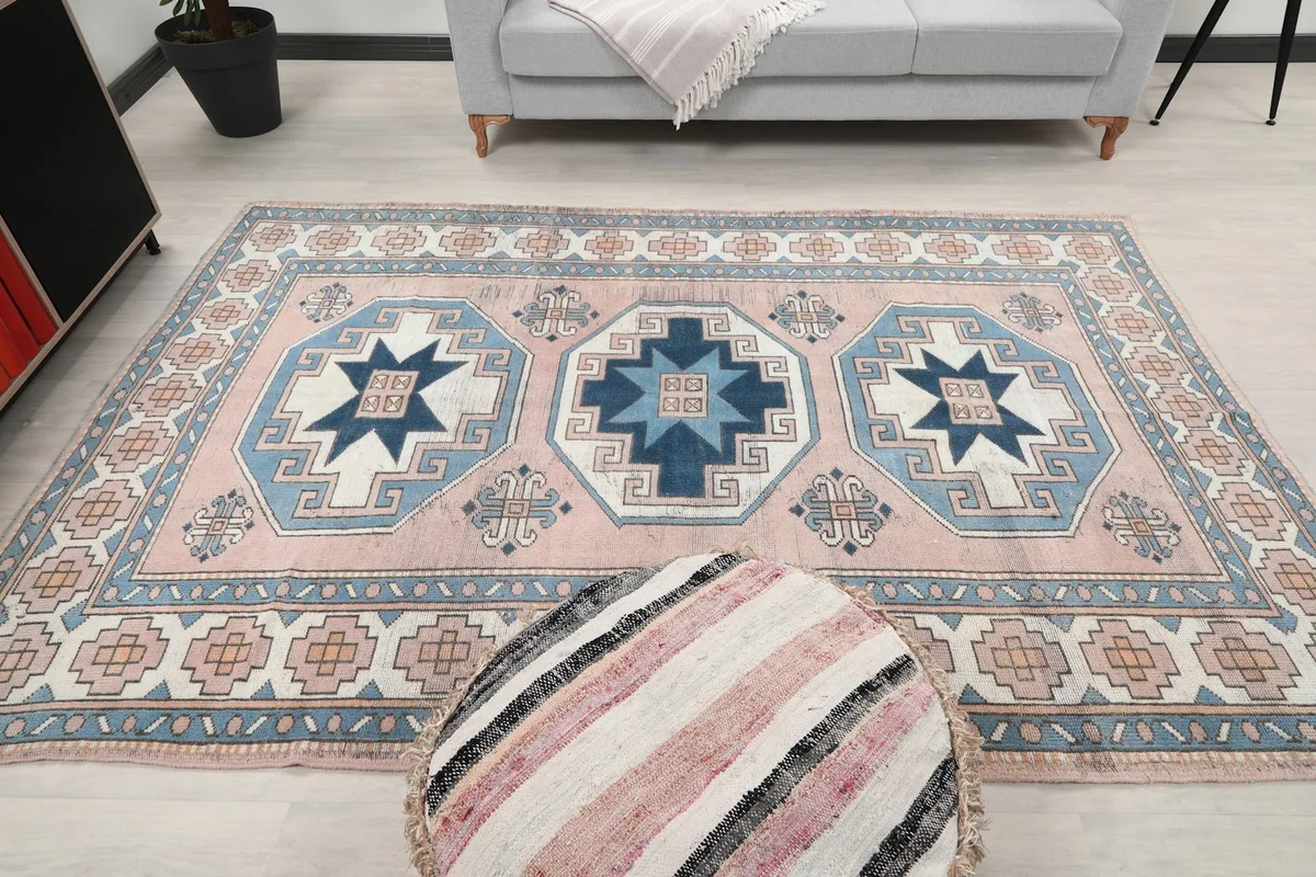 Overhead view of the rug in a room setting, emphasizing the three central medallion designs