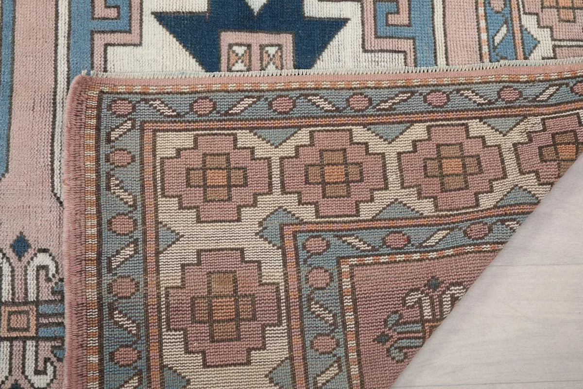 Underside view of the rug's corner, showing the tight knotting and construction