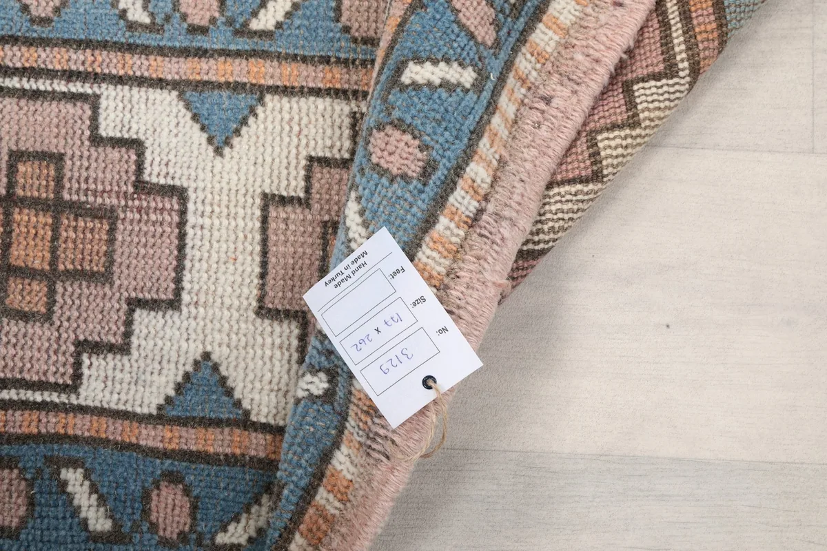 Close-up of the rug's label with size and item number, showing the reverse side of the rug